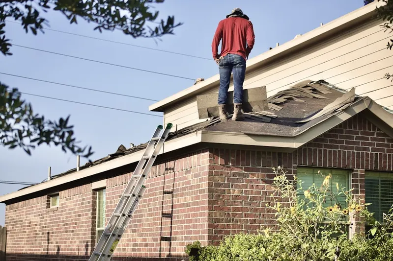 Professional roofer working on a residential roof in Sea Cliff